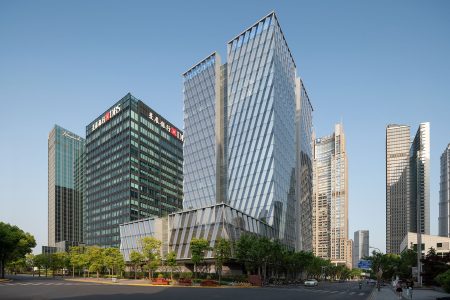 Both the tower and the podium of Kris Yao's Foxconn Shanghai Headquarters office tower are clad in angled, faceted glass.
