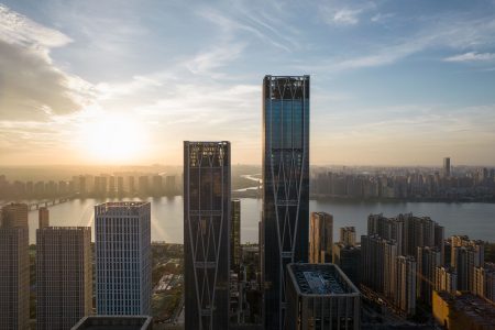 An early morning golden hour hero shot of Xiangjiang FFC's two landmark towers.